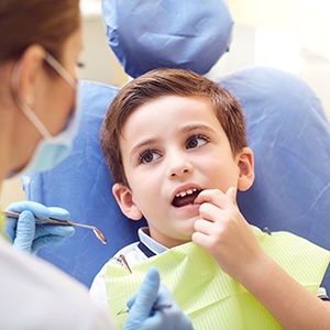 Little boy talking to his dentist about his teeth